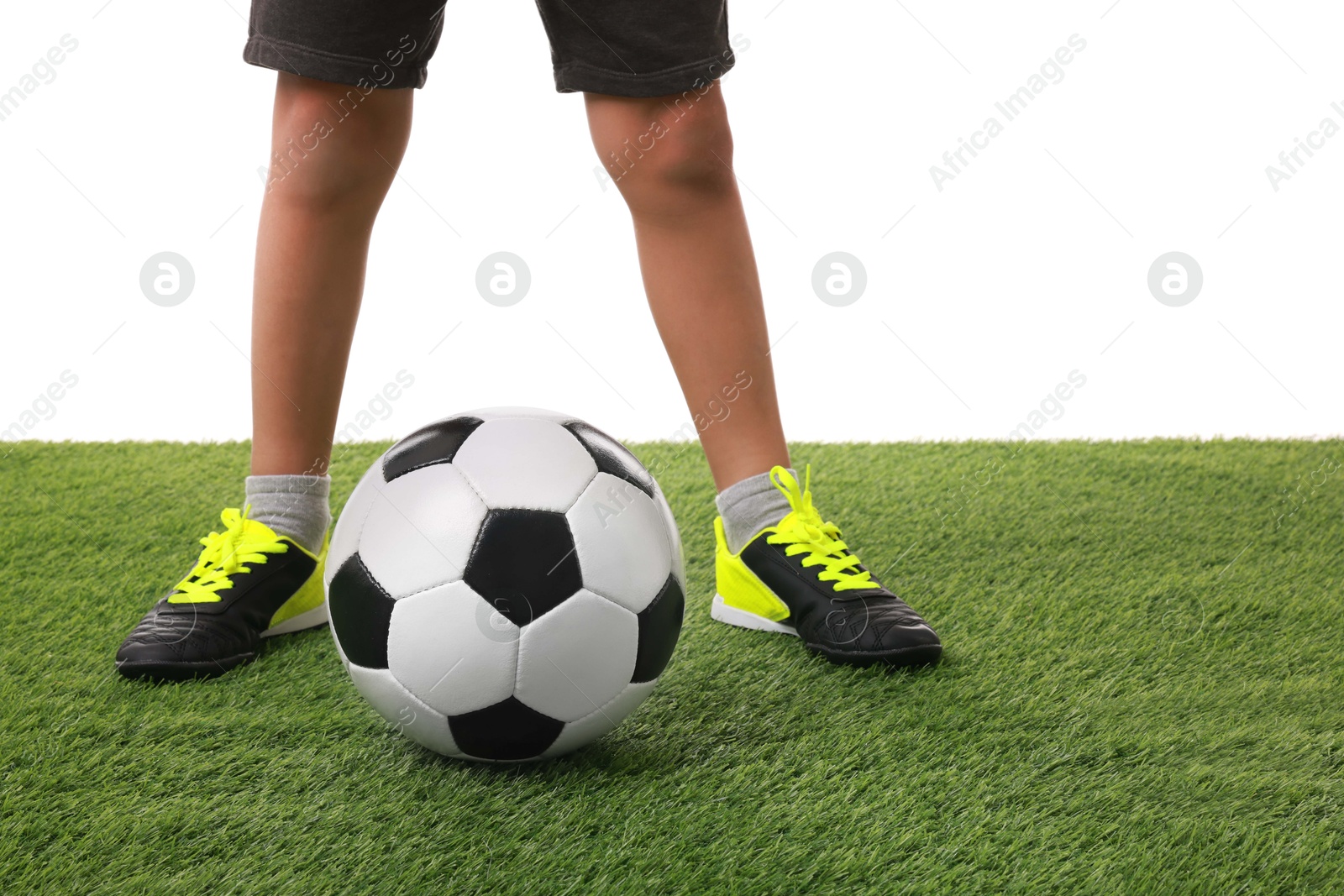 Photo of Football player with soccer ball on artificial grass against white background, closeup