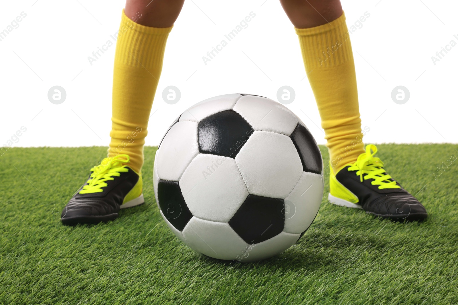 Photo of Football player with soccer ball on artificial grass against white background, closeup