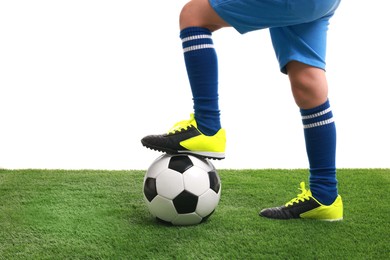 Football player with soccer ball on artificial grass against white background, closeup