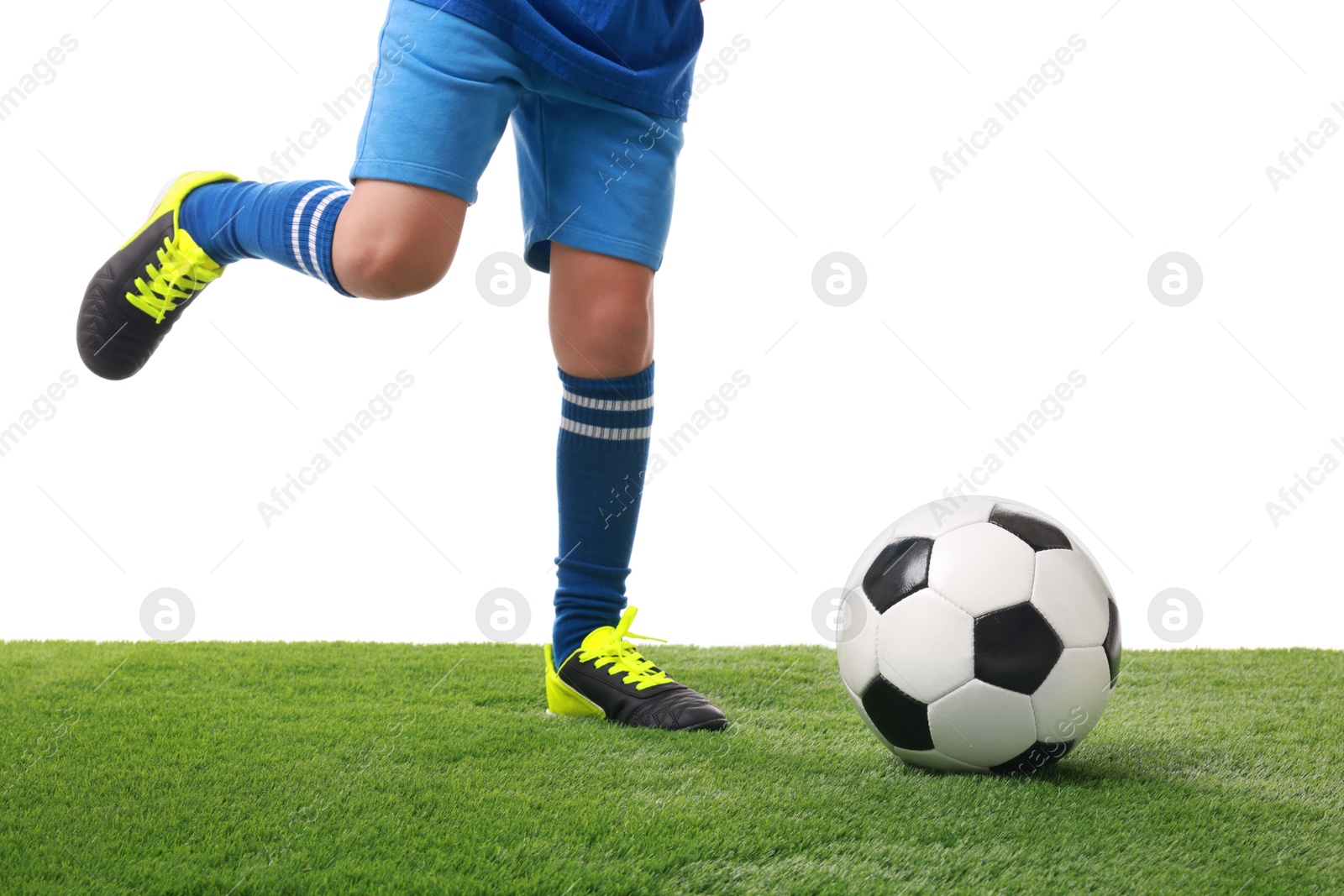 Photo of Football player with soccer ball on artificial grass against white background, closeup