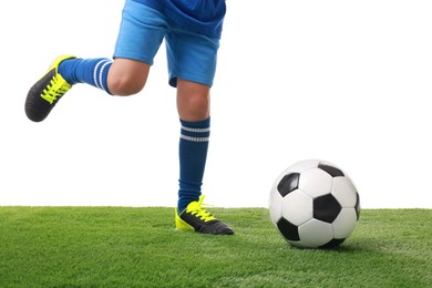 Football player with soccer ball on artificial grass against white background, closeup