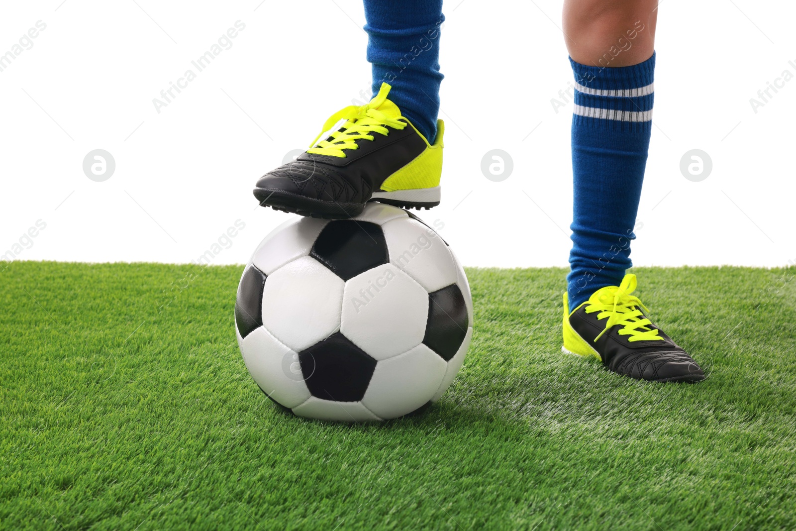 Photo of Football player with soccer ball on artificial grass against white background, closeup