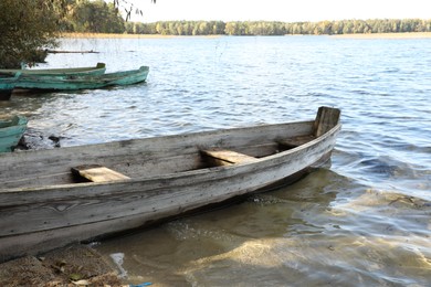 Many wooden boats on river. Water transportation