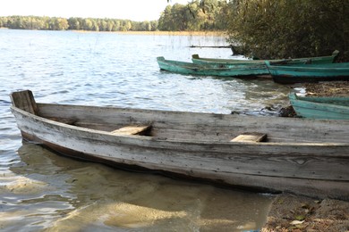 Many wooden boats on river. Water transportation