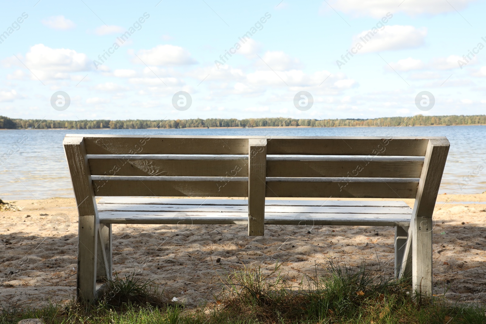 Photo of Wooden bench near river on sunny day