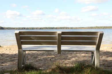 Photo of Wooden bench near river on sunny day