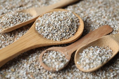 Photo of Different spoons with fresh rye bran, closeup