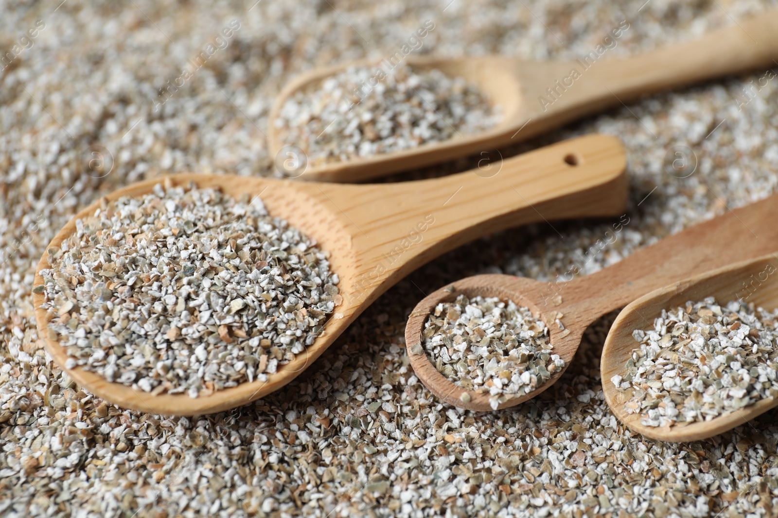 Photo of Different spoons with fresh rye bran, closeup