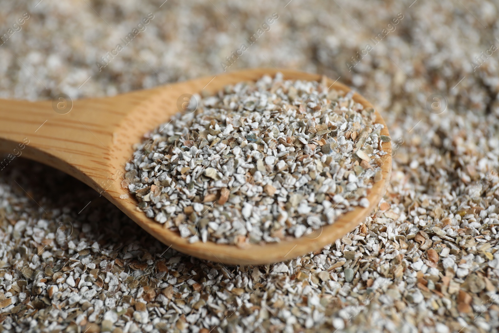 Photo of Wooden spoon with fresh rye bran, closeup