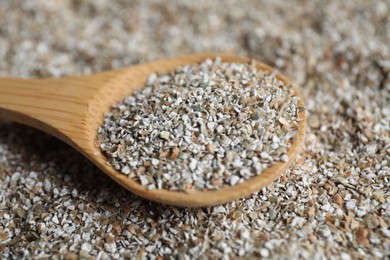 Photo of Wooden spoon with fresh rye bran, closeup