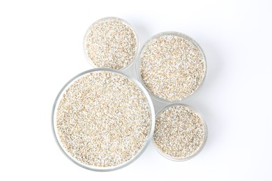 Photo of Fresh rye bran in bowls on white background, top view