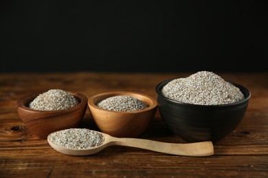 Photo of Fresh rye bran in bowls and spoon on wooden table, closeup