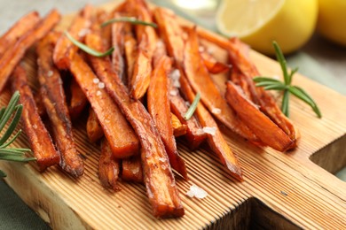 Photo of Delicious sweet potato fries with spices on table, closeup