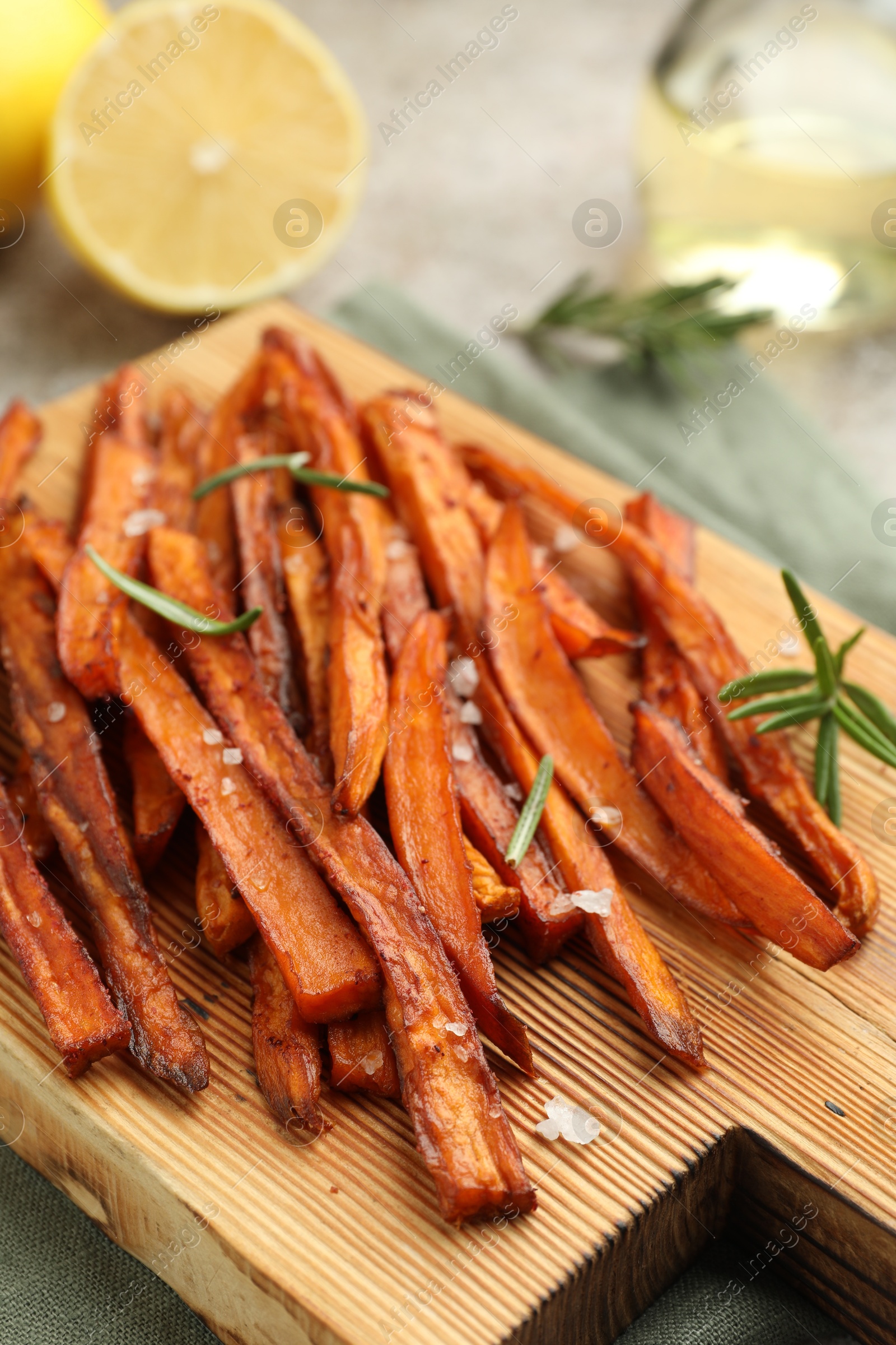 Photo of Delicious sweet potato fries with spices on table, closeup