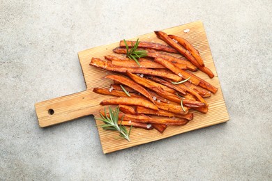 Photo of Delicious sweet potato fries with spices on grey table, top view