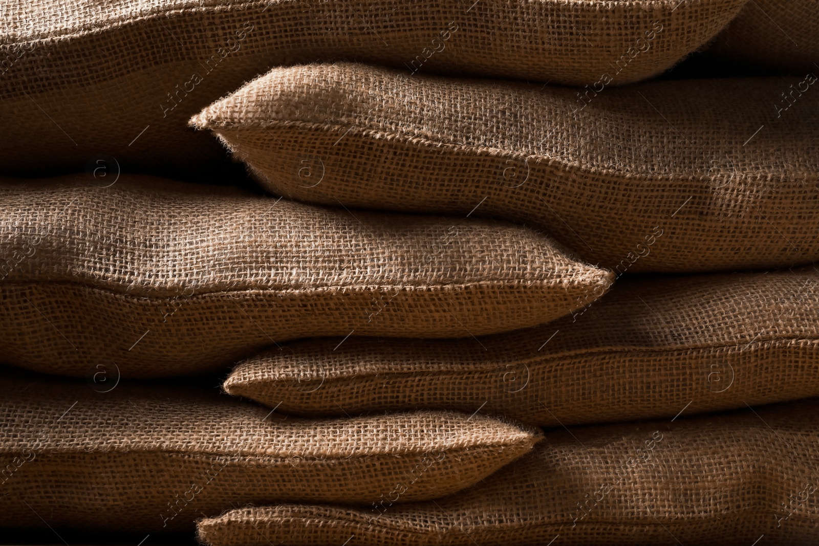 Photo of Group of burlap sacks as background, closeup