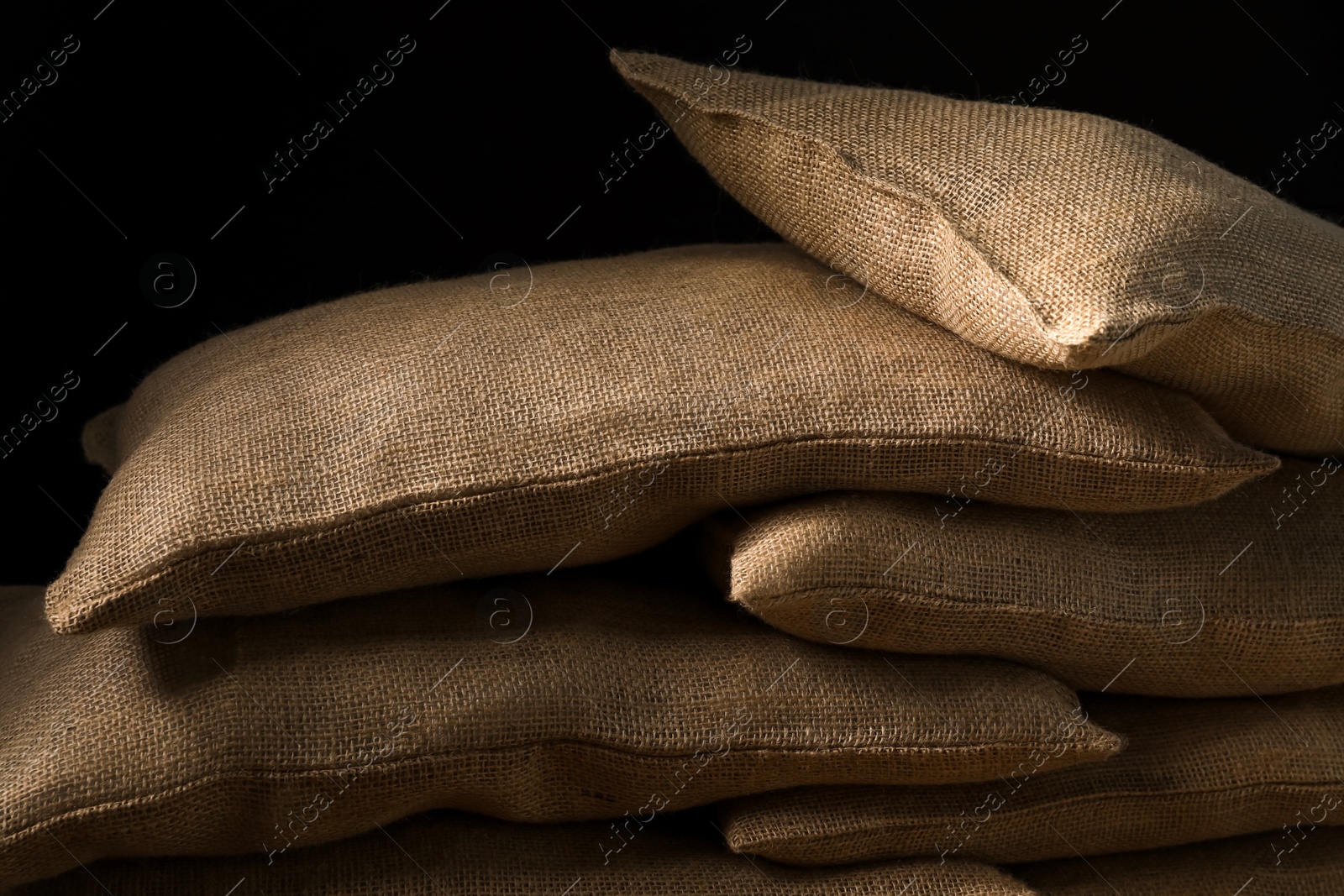 Photo of Group of burlap sacks against black background