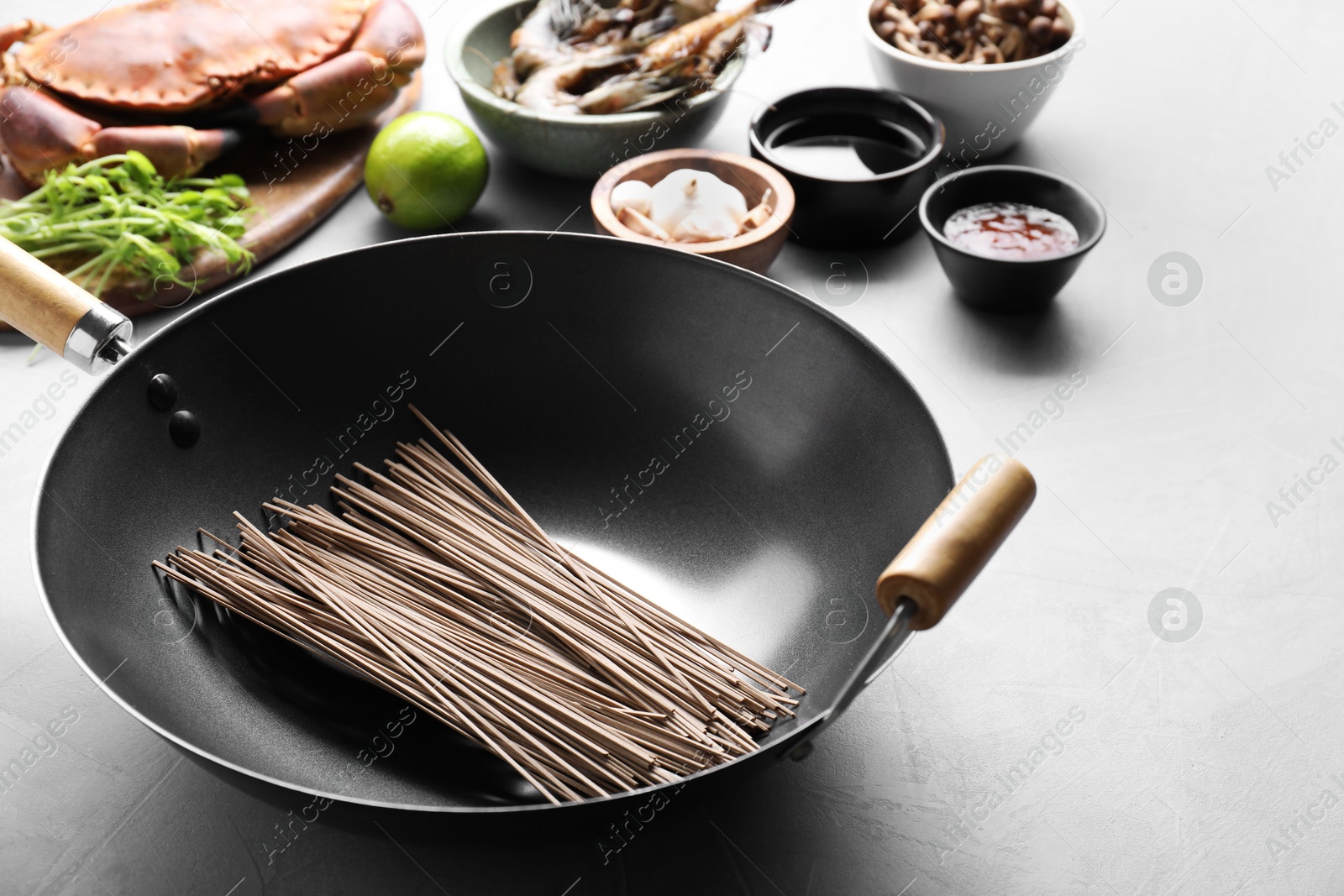 Photo of Different ingredients for wok on light grey table