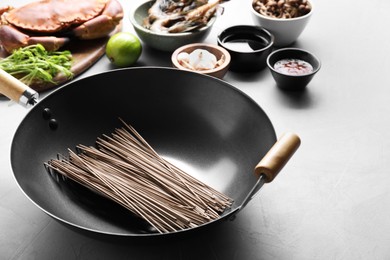 Photo of Different ingredients for wok on light grey table