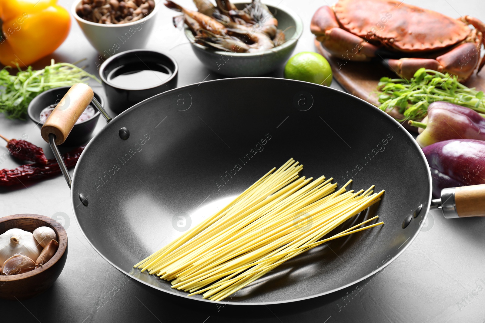 Photo of Different ingredients for wok on light grey table