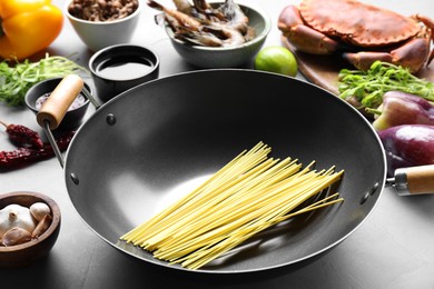 Different ingredients for wok on light grey table