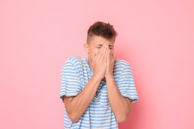 Photo of Portrait of scared young man on pink background