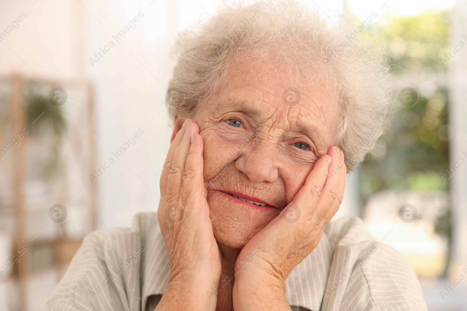 Photo of Portrait of beautiful senior woman against blurred background