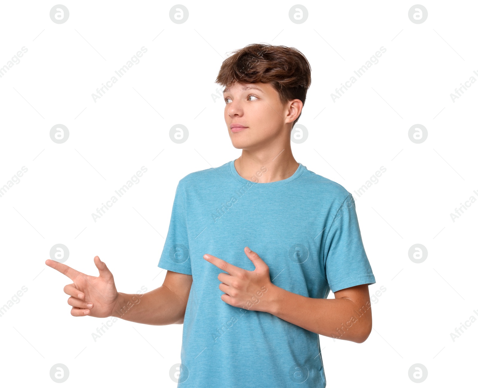 Photo of Teenage boy pointing at something on white background