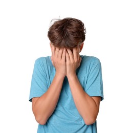 Photo of Scared teenage boy covering face with hands on white background