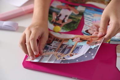 Creating vision board with different pictures at light table, closeup