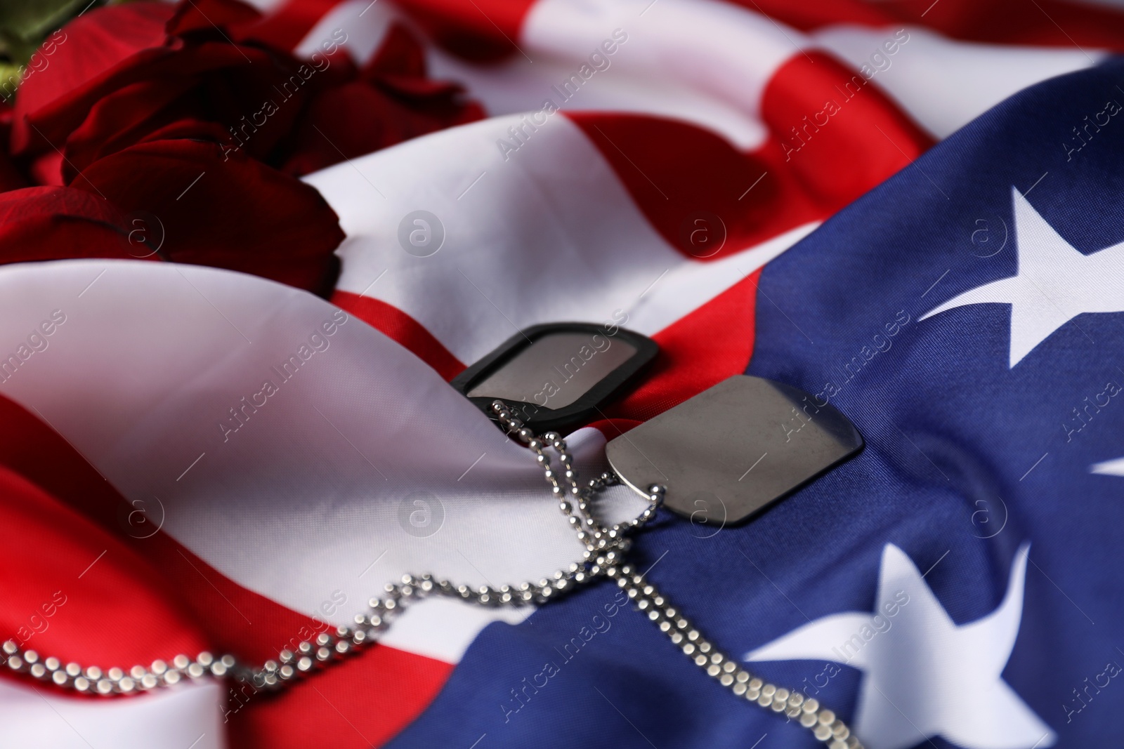 Photo of Veterans day. Army tokens and American flag, closeup