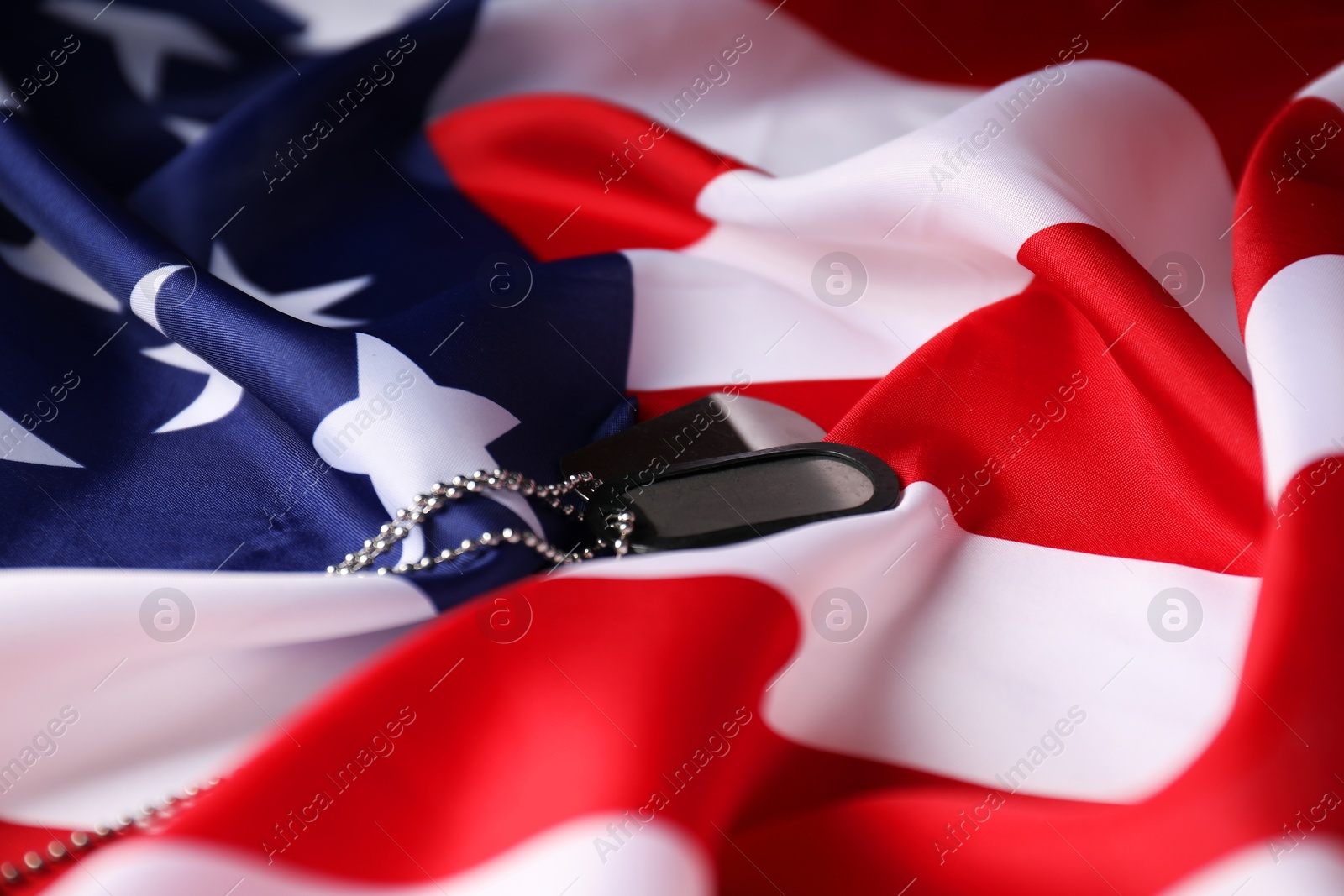 Photo of Veterans day. Army tokens and American flag, closeup