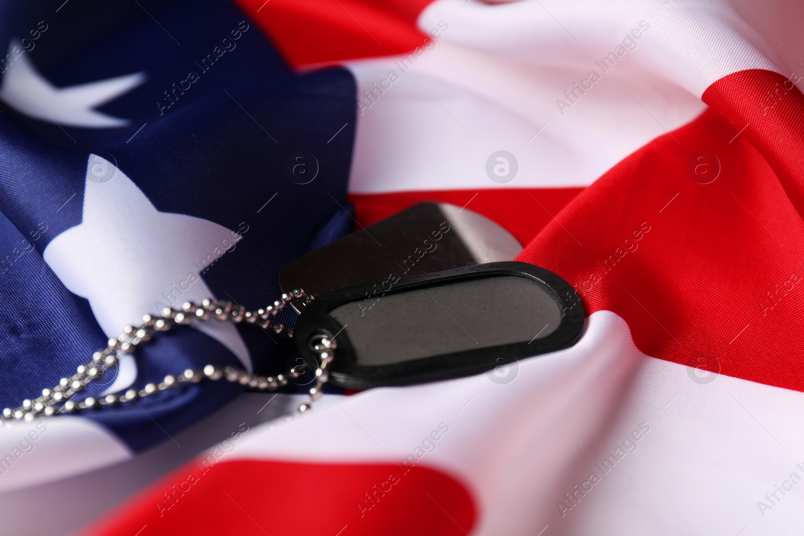 Photo of Veterans day. Army tokens and American flag, closeup