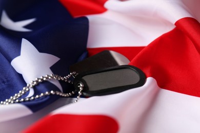 Photo of Veterans day. Army tokens and American flag, closeup