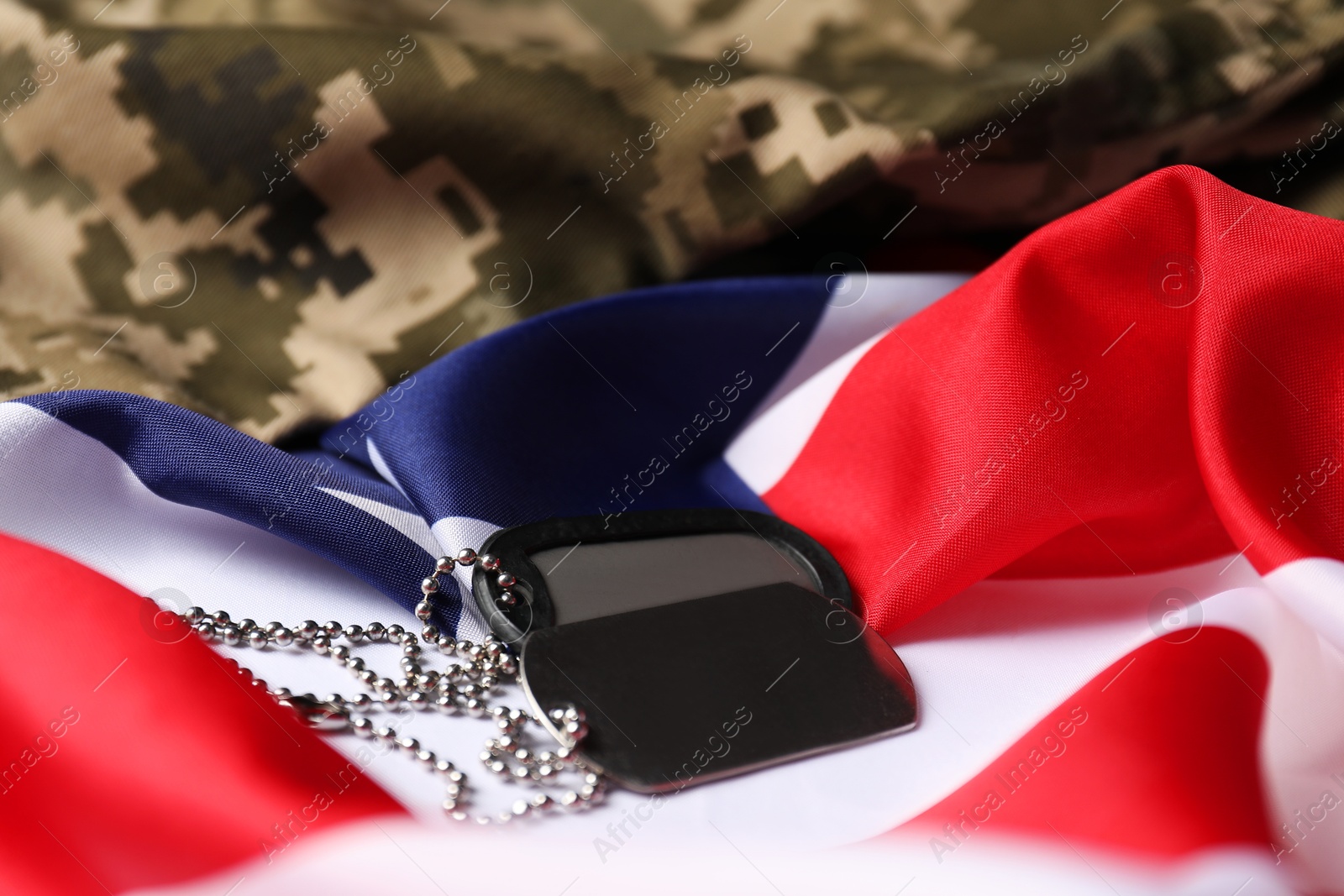 Photo of Veterans day. Army tokens, American flag and military uniform, closeup