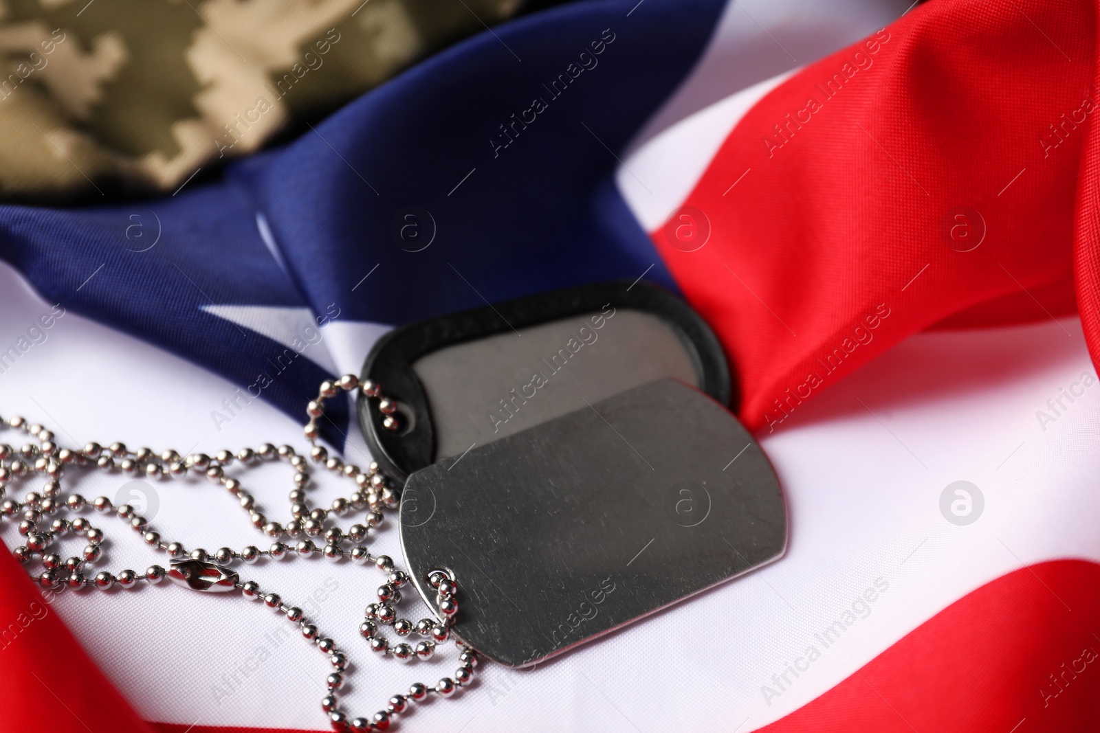 Photo of Veterans day. Army tokens, American flag and military uniform, closeup