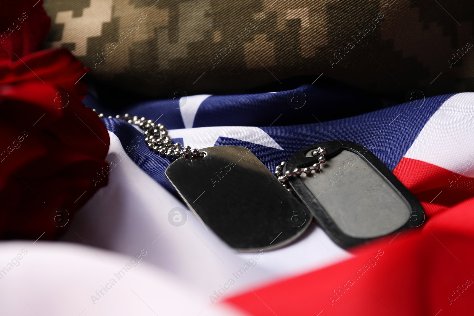 Photo of Veterans day. Army tokens, American flag and military uniform, closeup