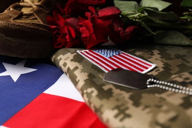 Photo of Veterans day. USA army patch, American flag, roses, token and military uniform, closeup