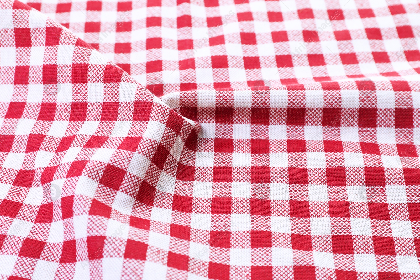 Photo of Crumpled tablecloth with checkered pattern as background, closeup