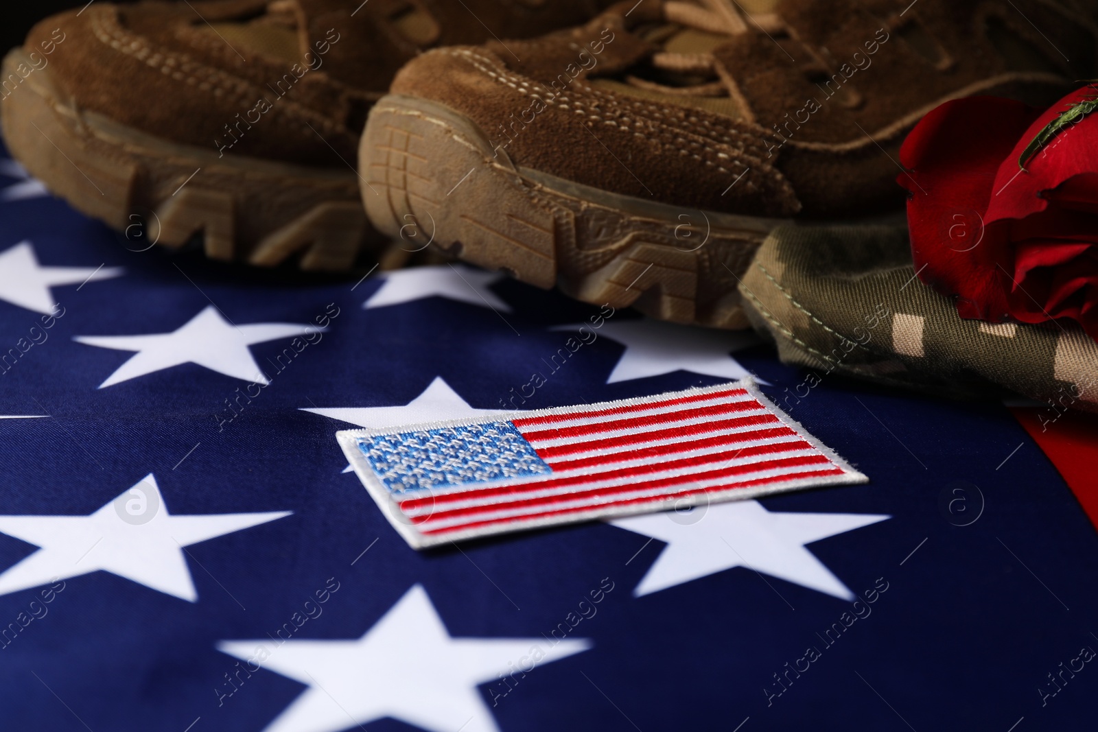 Photo of Veterans day. USA army patch, American flag, roses and military uniform, closeup