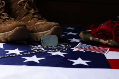 Photo of Veterans day. USA army patch, American flag, roses, token and military uniform, closeup