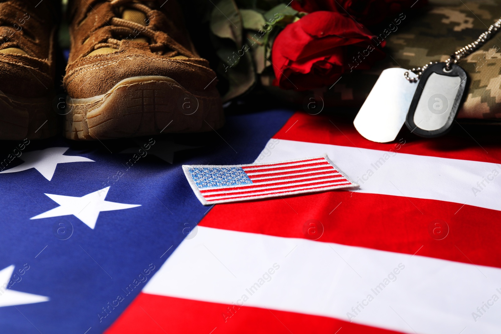 Photo of Veterans day. USA army patch, tokens, American flag, roses and military uniform, closeup