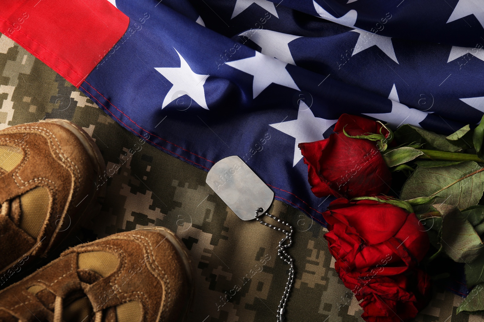 Photo of Veterans day. Army token, American flag, roses and military uniform, flat lay