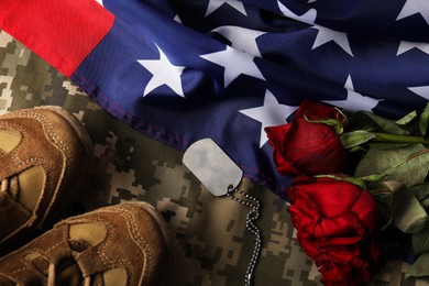 Photo of Veterans day. Army token, American flag, roses and military uniform, flat lay