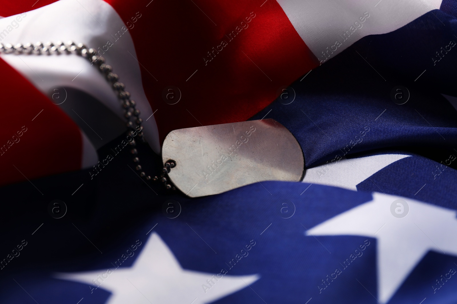 Photo of Veterans day. Army token and American flag, closeup