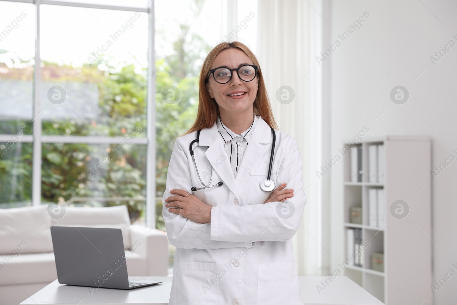 Photo of Portrait of smiling doctor with stethoscope in clinic