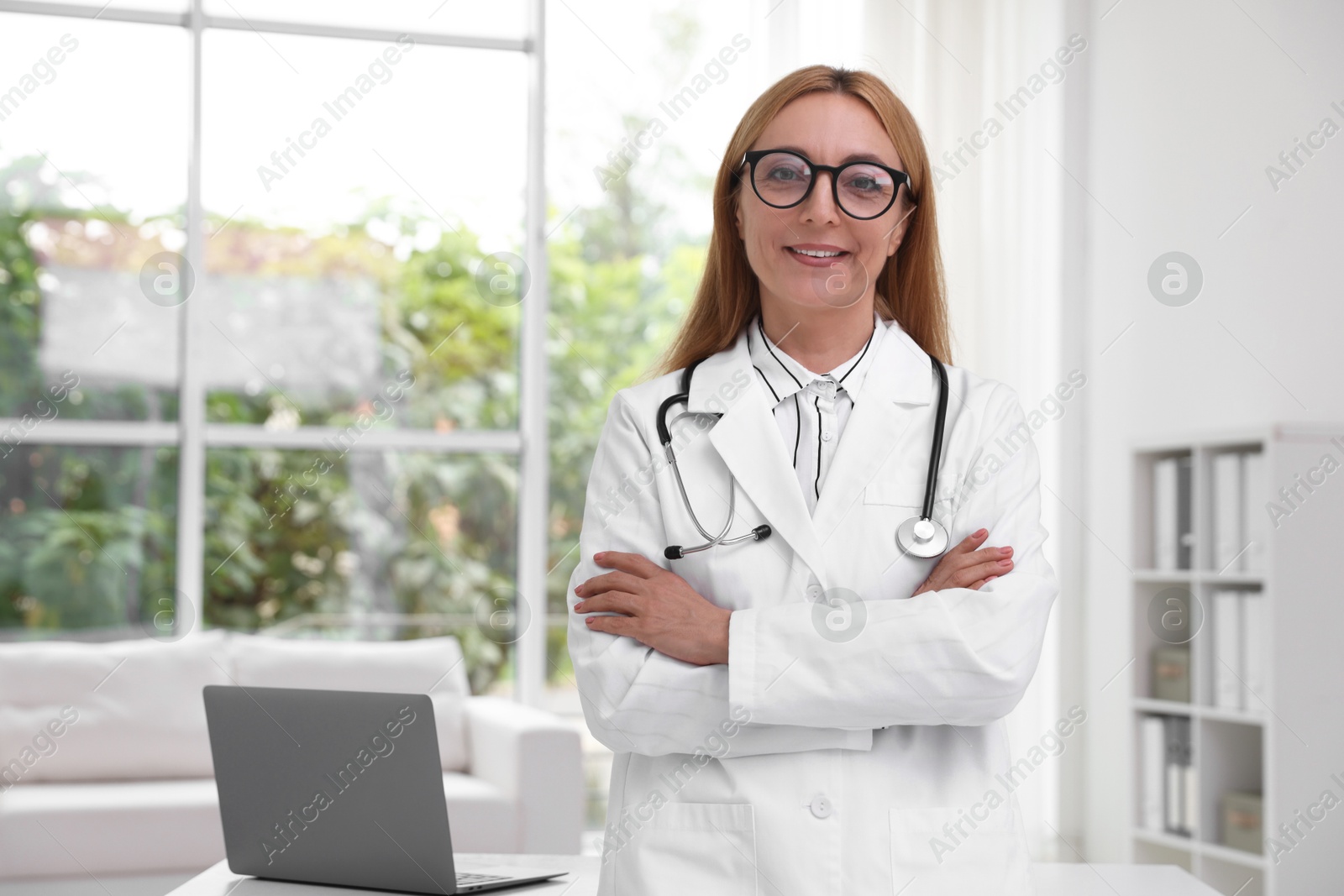 Photo of Portrait of smiling doctor with stethoscope in clinic