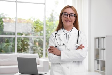 Photo of Portrait of smiling doctor with stethoscope in clinic