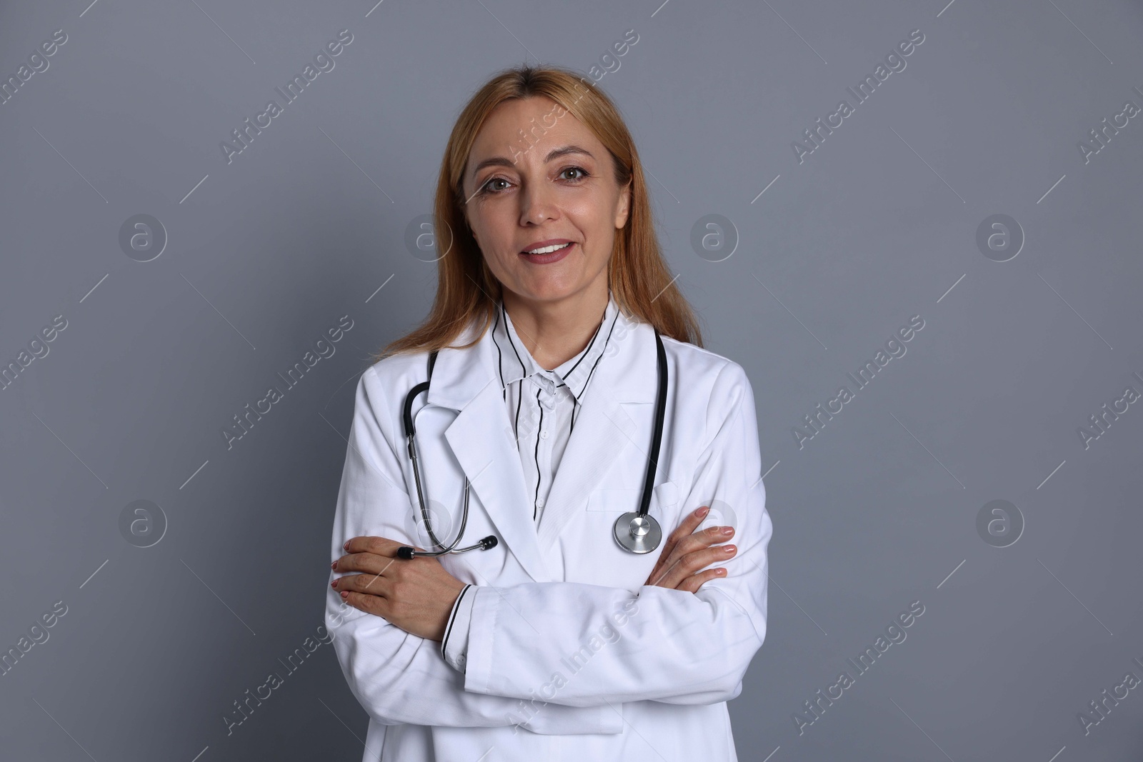 Photo of Portrait of doctor with stethoscope on gray background