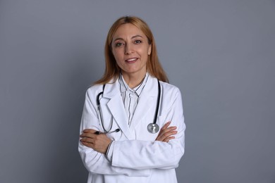 Portrait of doctor with stethoscope on gray background